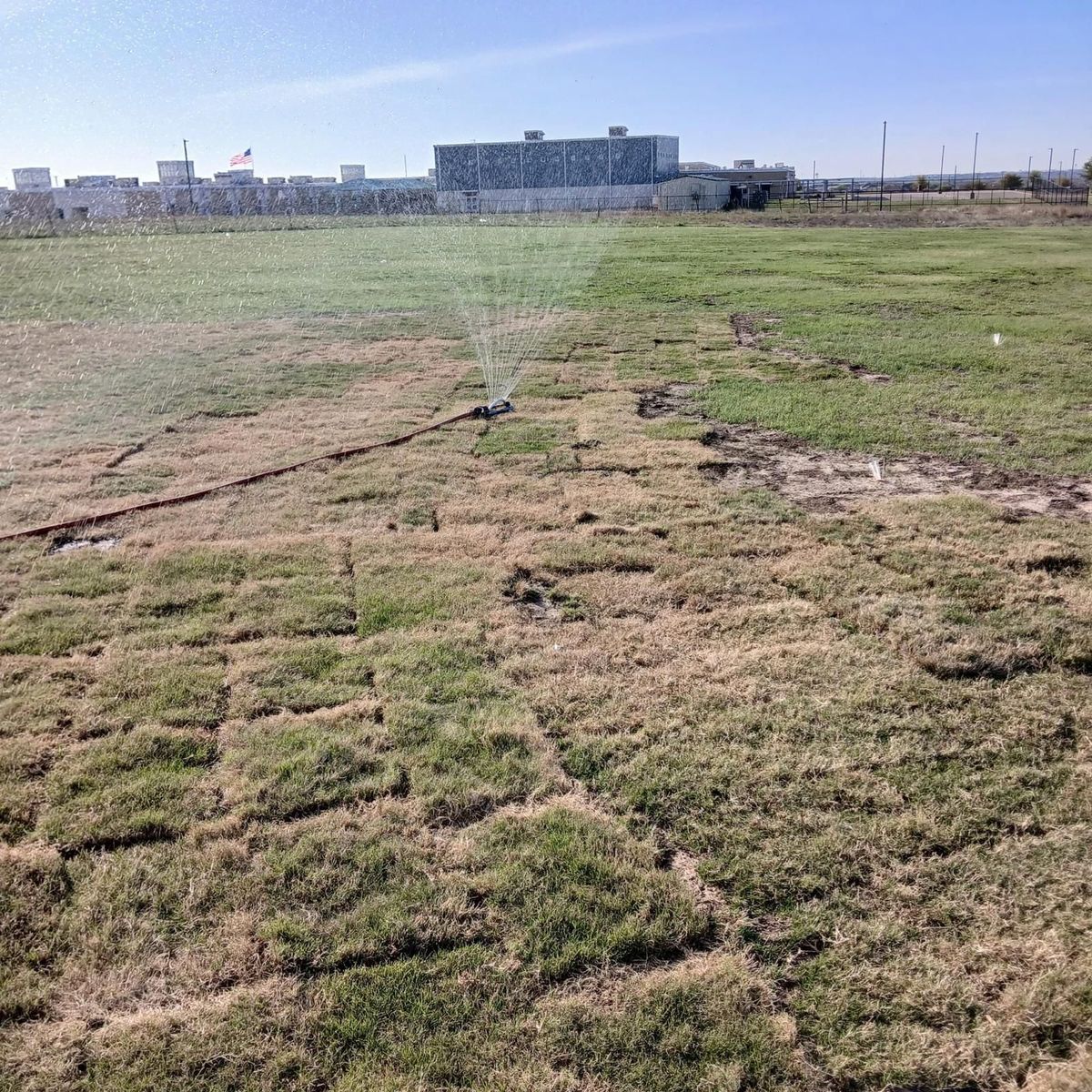 Irrigation sprinklers watering new sod at Hutto Cricket Ground
